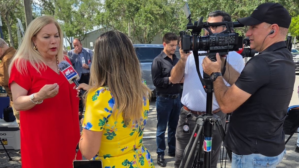 Supervisor of Elections Alina Garcia and Peru Consul General David Vergara Pilares speaking with Peruvian community leaders about the elections in the exterior prior to a press event.