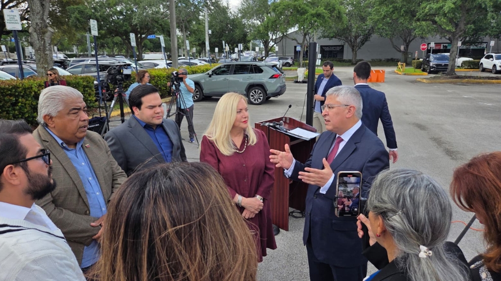 Supervisor of Elections Alina Garcia and Peru Consul General David Vergara Pilares speaking with Peruvian community leaders about the elections in the exterior prior to a press event.